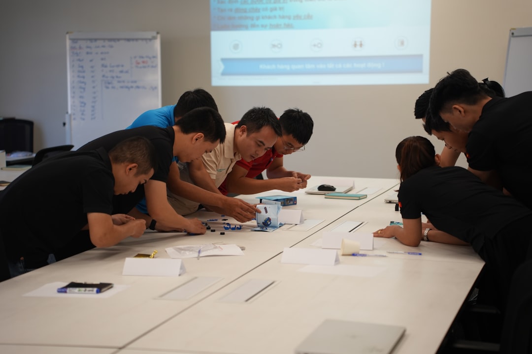 who-we-are team-collaborating-on-a-project-at-a-table-8s6ktiplfds